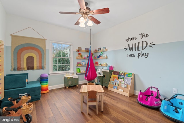 game room with a ceiling fan, visible vents, wood finished floors, and baseboards