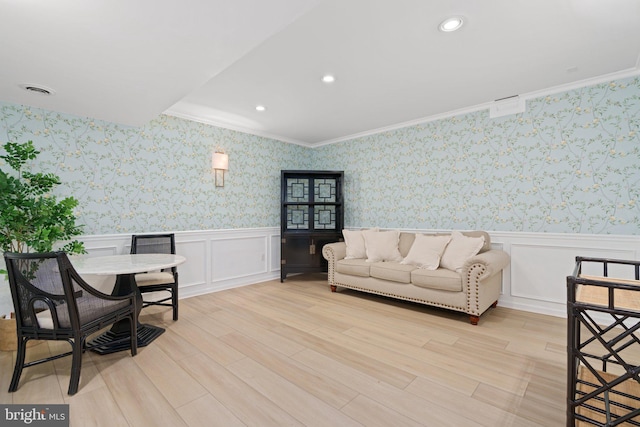 living room featuring wainscoting, wallpapered walls, and light wood-type flooring