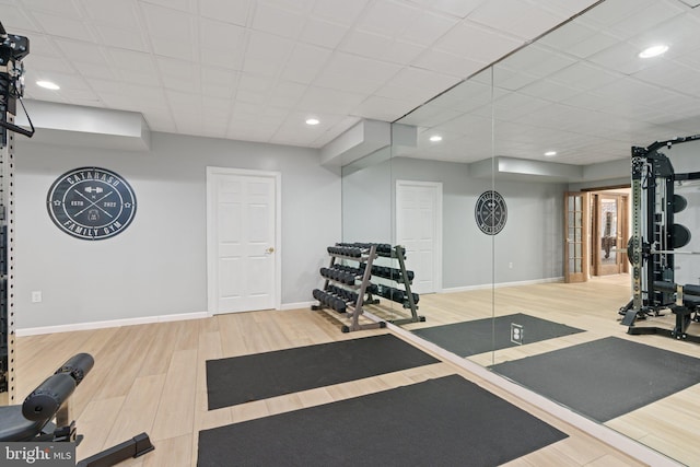 exercise area with recessed lighting, baseboards, and wood finished floors