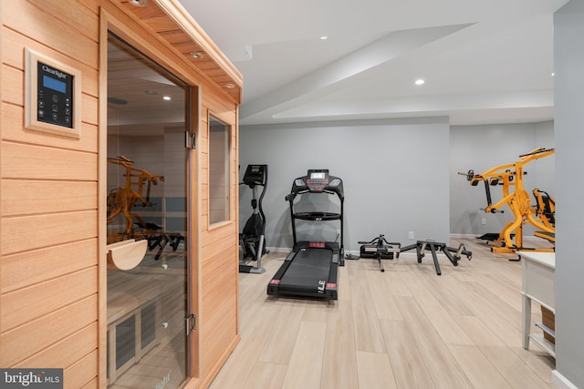 workout area featuring recessed lighting, light wood-style floors, baseboards, and a sauna