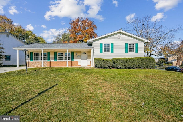 tri-level home with a porch and a front lawn