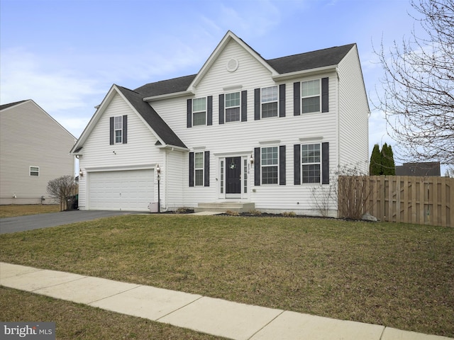 colonial inspired home with aphalt driveway, an attached garage, fence, and a front yard