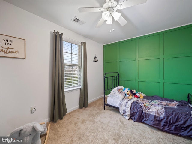 carpeted bedroom featuring visible vents, baseboards, and ceiling fan