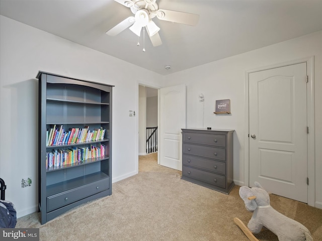 bedroom with ceiling fan, baseboards, and carpet floors