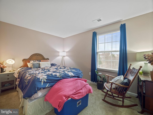 carpeted bedroom featuring visible vents and baseboards