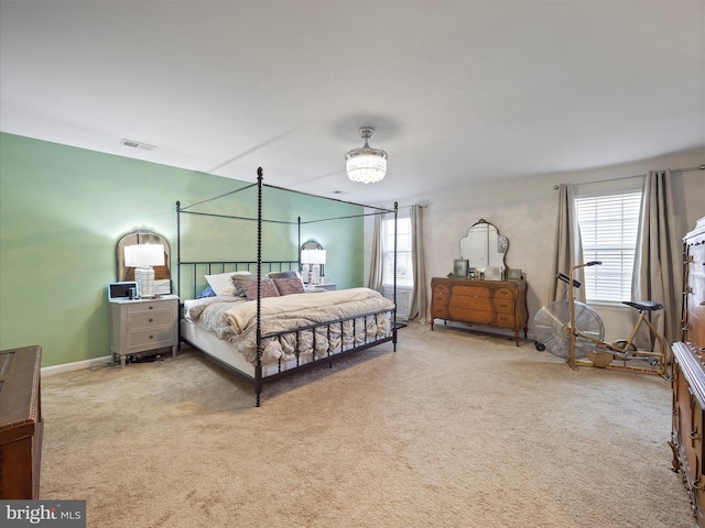 bedroom featuring visible vents, baseboards, and carpet