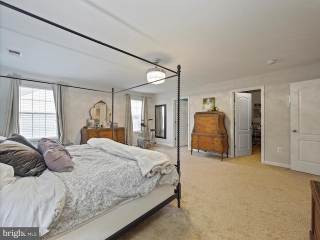 bedroom featuring light colored carpet, visible vents, and baseboards