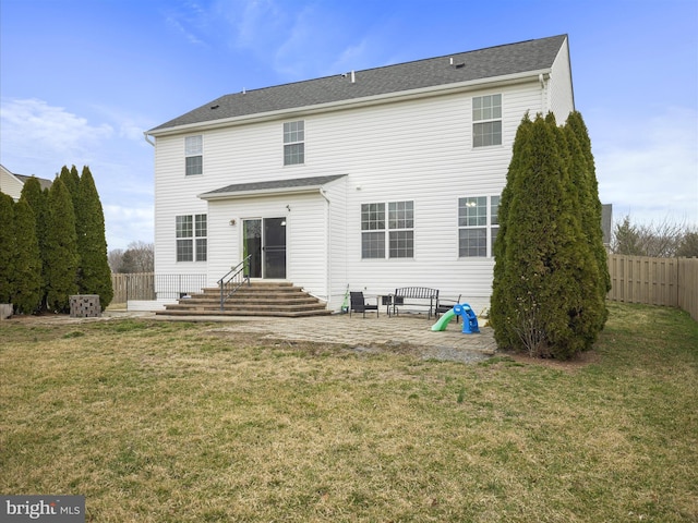 rear view of property with a patio area, fence, a lawn, and entry steps