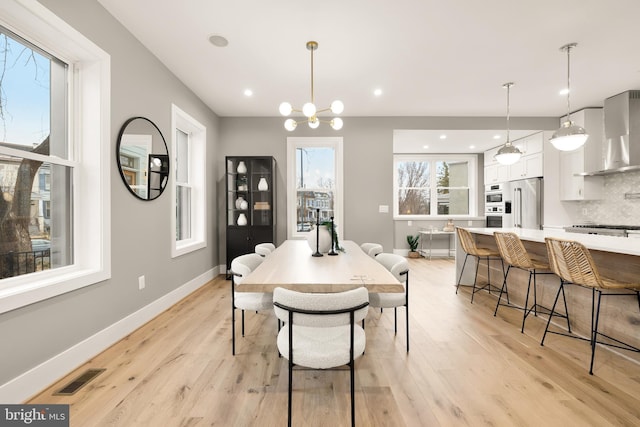 dining area with visible vents, baseboards, an inviting chandelier, recessed lighting, and light wood-style floors