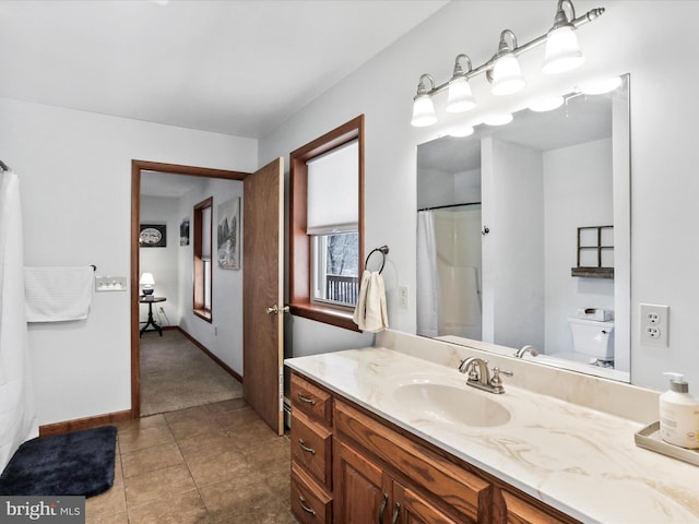 full bath featuring toilet, curtained shower, tile patterned flooring, baseboards, and vanity