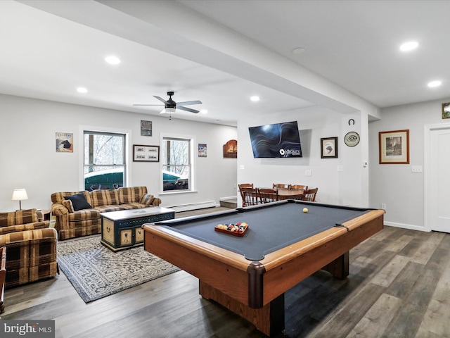 recreation room with recessed lighting, a baseboard radiator, and wood finished floors