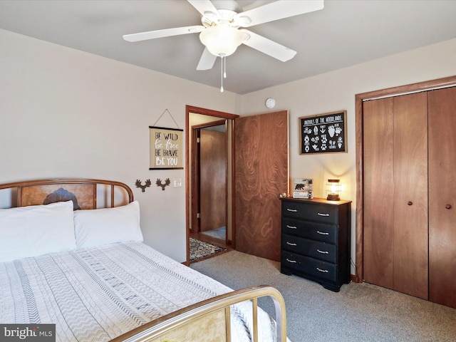 carpeted bedroom with a ceiling fan and a closet