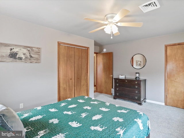 bedroom with visible vents, a closet, carpet flooring, baseboards, and ceiling fan