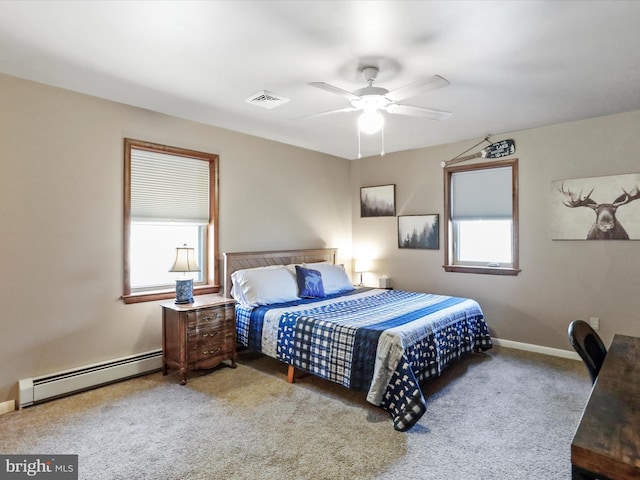 bedroom featuring a ceiling fan, carpet, visible vents, baseboards, and a baseboard heating unit