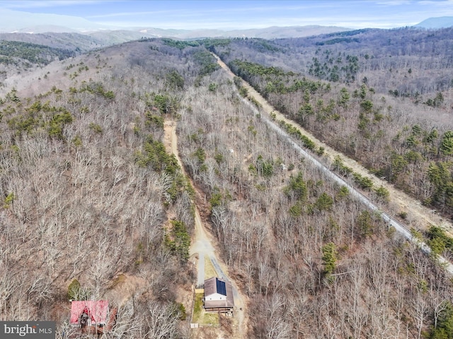 aerial view featuring a forest view and a mountain view