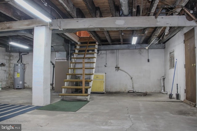 unfinished basement with electric water heater and stairs