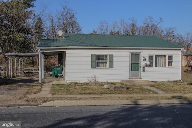 view of front of home featuring a carport and metal roof