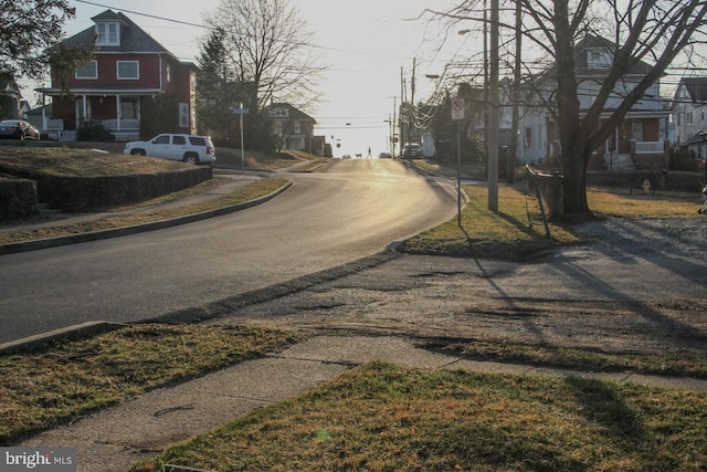 view of road featuring traffic signs, curbs, and sidewalks