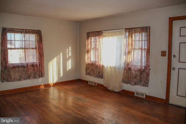 entrance foyer with visible vents, baseboards, and wood finished floors