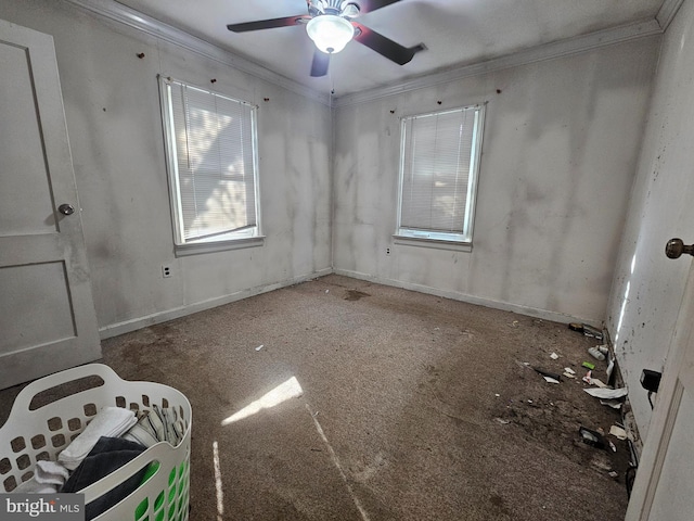 unfurnished room with baseboards, a ceiling fan, and ornamental molding