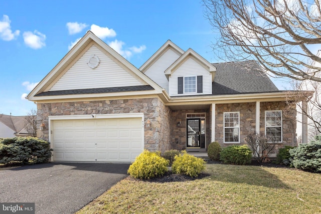 traditional-style home with a garage, stone siding, and driveway