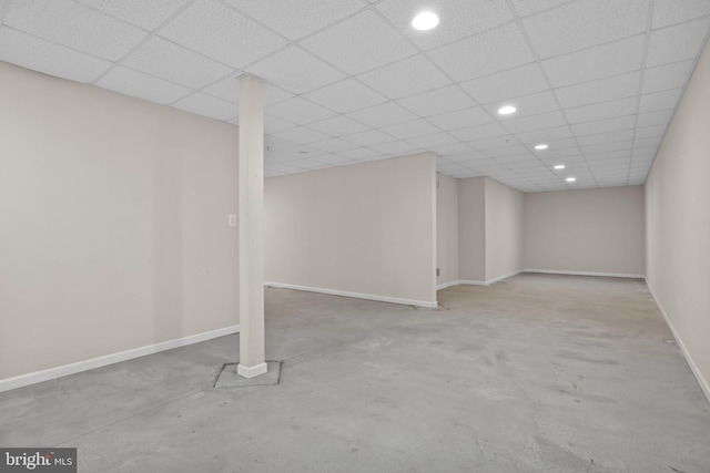 finished basement featuring recessed lighting, baseboards, and a drop ceiling