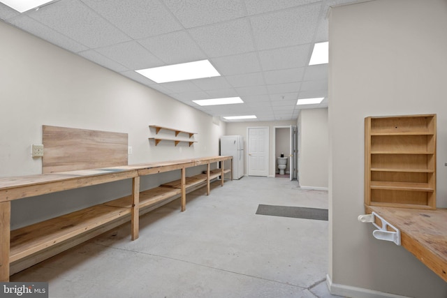 interior space featuring a workshop area and a paneled ceiling