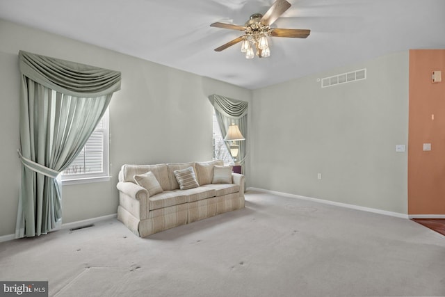 unfurnished living room featuring visible vents, baseboards, ceiling fan, and carpet floors