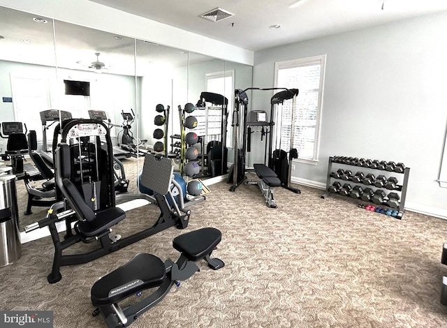 gym featuring baseboards, visible vents, and carpet floors