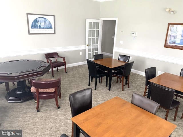 dining room with baseboards and carpet floors