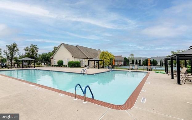 pool featuring a gazebo and a patio area