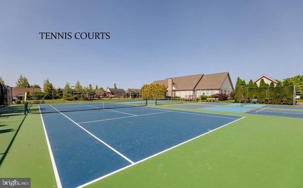 view of sport court featuring fence