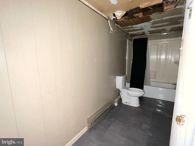 full bathroom with toilet and wood walls