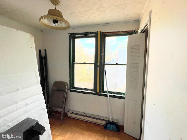 interior space with a baseboard heating unit and light wood-style flooring