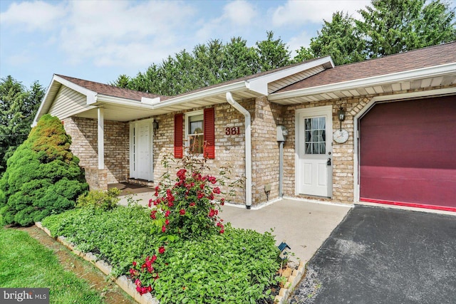 381 N Main St, Spring Grove, PA 17362 - ranch-style home with an attached garage, covered porch, roof with shingles, and stone siding