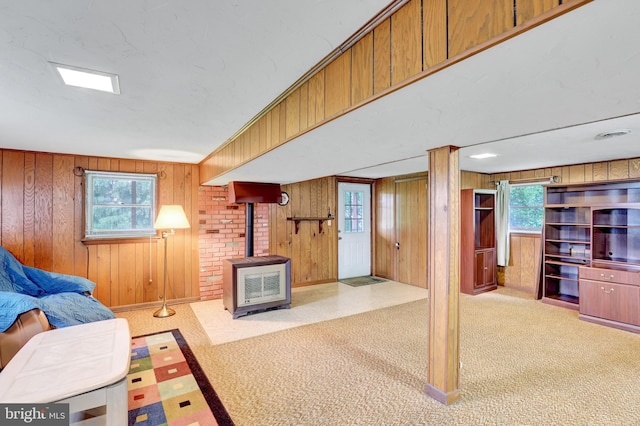381 N Main St, Spring Grove, PA 17362 - carpeted living area featuring a wood stove and wood walls