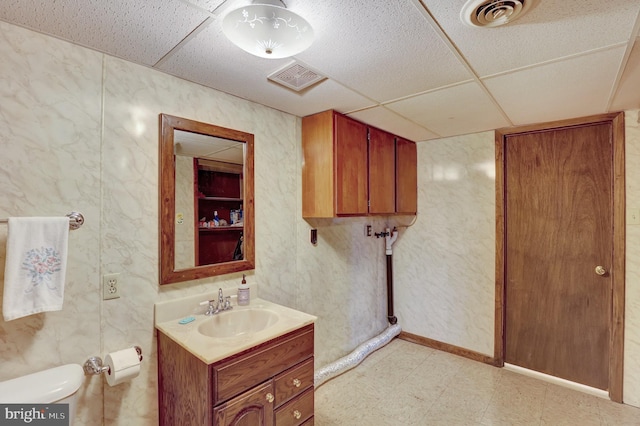 381 N Main St, Spring Grove, PA 17362 - bathroom featuring a paneled ceiling, vanity, tile patterned floors, and toilet