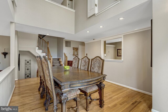 12521 N Lake Ct, Fairfax, VA 22033 - dining area featuring visible vents, a high ceiling, light wood finished floors, recessed lighting, and stairs