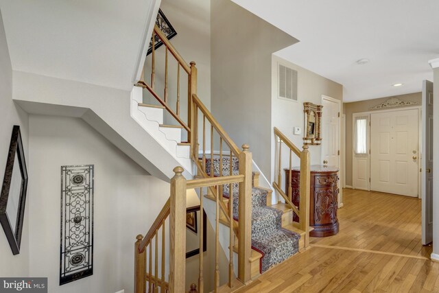 12521 N Lake Ct, Fairfax, VA 22033 - stairs with wood finished floors, baseboards, and visible vents