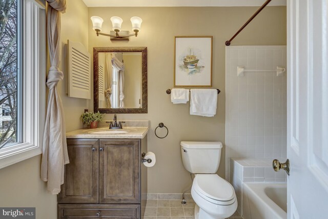 12521 N Lake Ct, Fairfax, VA 22033 - bathroom with vanity, tile patterned flooring, toilet, washtub / shower combination, and baseboards