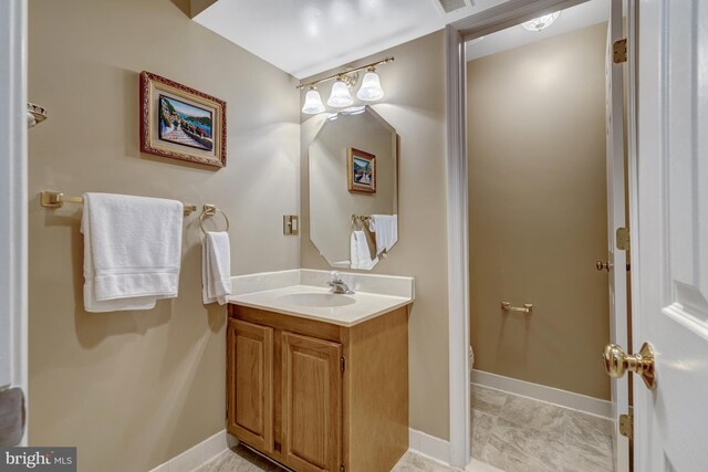 12521 N Lake Ct, Fairfax, VA 22033 - bathroom with toilet, visible vents, baseboards, and vanity