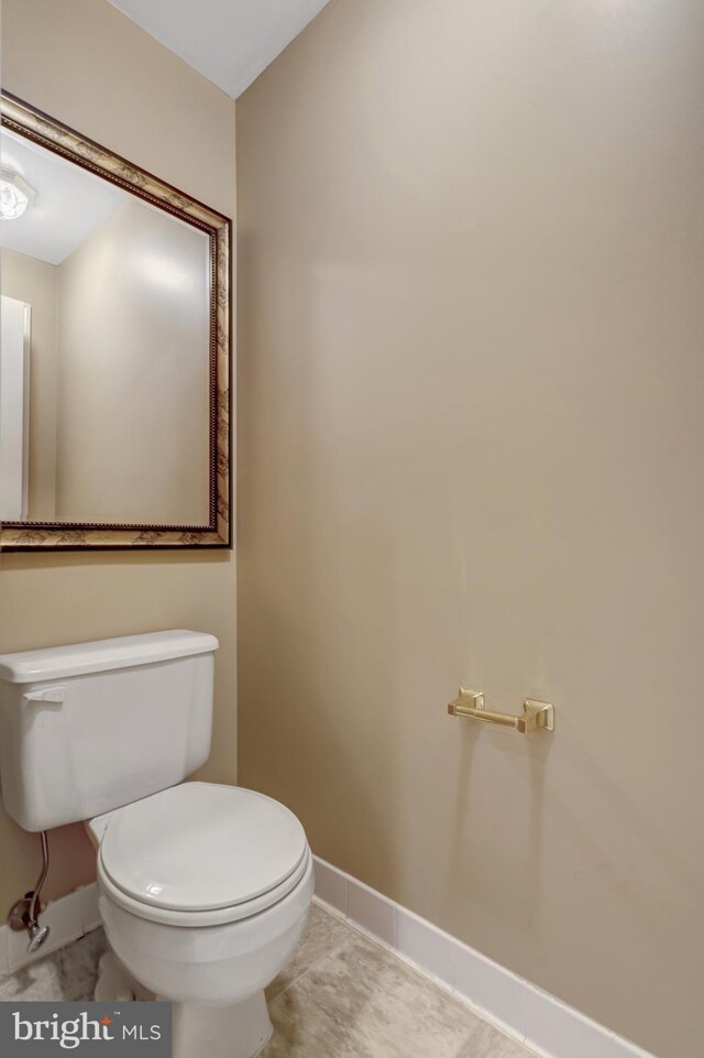 12521 N Lake Ct, Fairfax, VA 22033 - half bathroom with toilet, tile patterned flooring, and baseboards