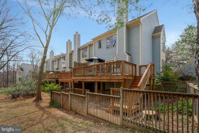12521 N Lake Ct, Fairfax, VA 22033 - back of house with a chimney, a wooden deck, and stairs
