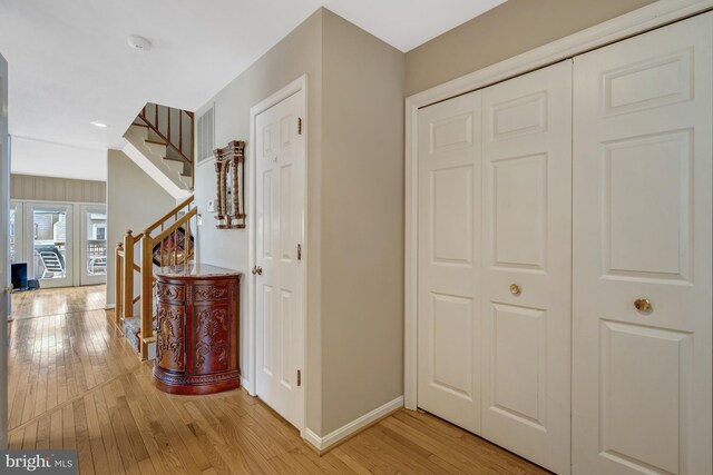 12521 N Lake Ct, Fairfax, VA 22033 - corridor featuring stairs, light wood-style floors, and baseboards