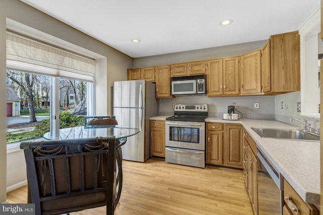 12521 N Lake Ct, Fairfax, VA 22033 - kitchen featuring light countertops, light wood-style floors, appliances with stainless steel finishes, and a sink