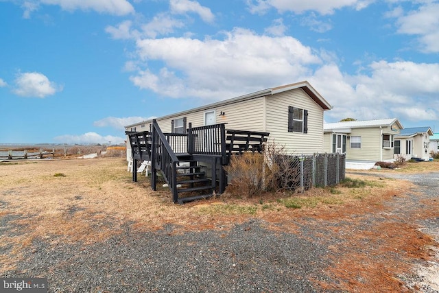 39952 Summers End Rd Unit 7244, Fenwick Island, DE 19944 - view of property exterior with a wooden deck and stairway