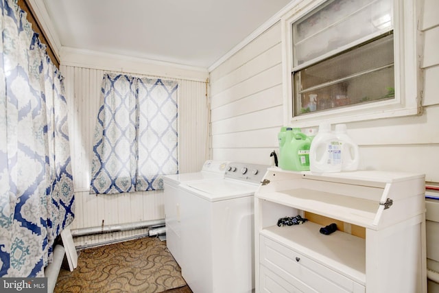 washroom featuring laundry area, crown molding, wooden walls, and separate washer and dryer