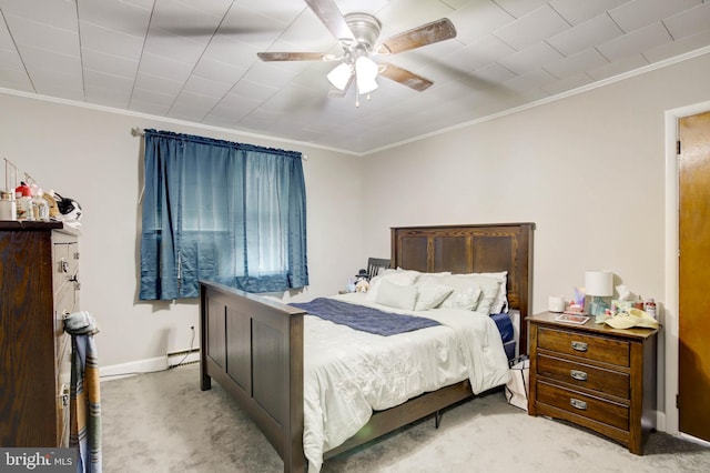 bedroom featuring light colored carpet, crown molding, and baseboards