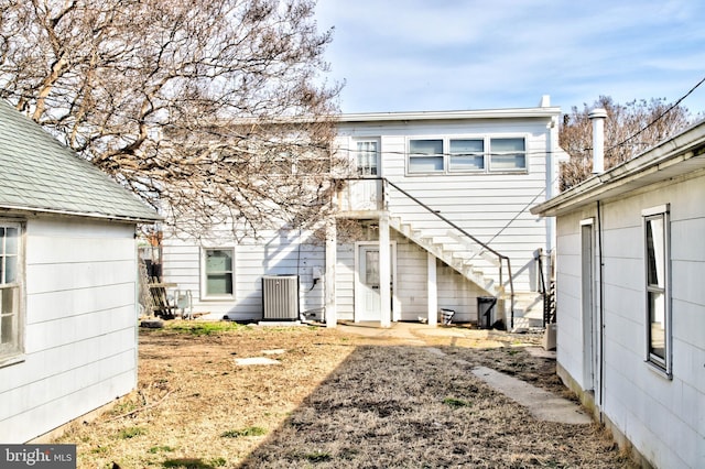 rear view of property with stairway and central air condition unit