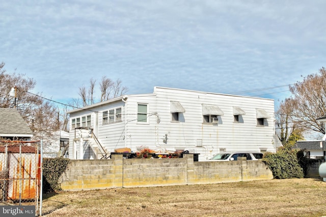 view of home's exterior featuring a yard and fence